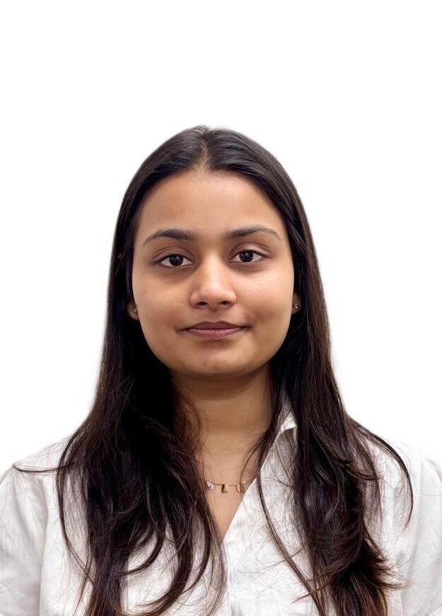 Professional portrait of a young woman in a white shirt with a neutral background.